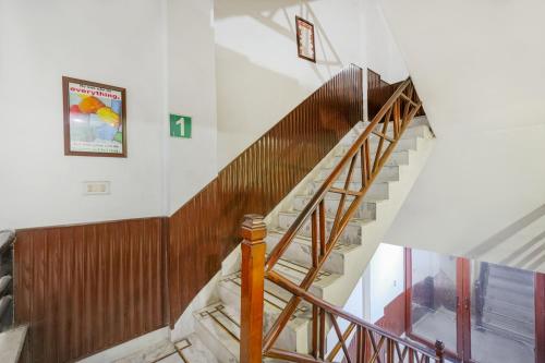 a staircase in a building with a wooden railing at Hotel Abhi international in Pathānkot