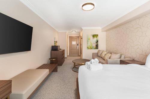 a hotel room with a bed and a couch at Velora Hinton, an Ascend Collection Hotel in Hinton