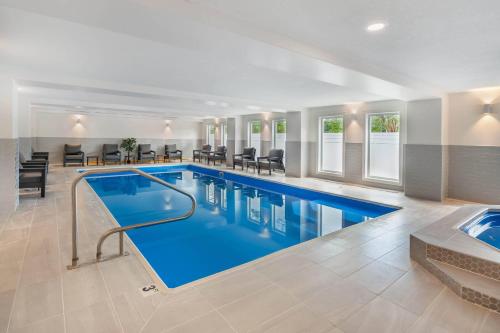 a large swimming pool with blue water in a building at Velora Hinton, an Ascend Collection Hotel in Hinton