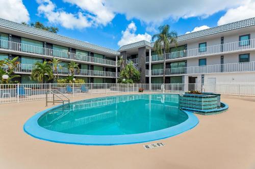 a swimming pool in front of a building at Quality Inn & Suites at Tropicana Field in St. Petersburg