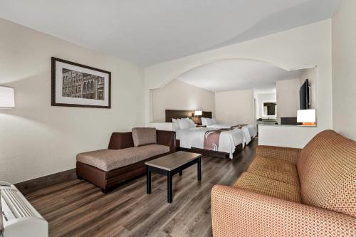 a hotel room with a bed and a couch at Quality Inn & Suites near Robins Air Force Base in Warner Robins