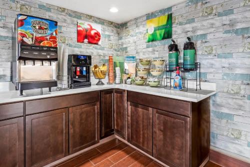 a kitchen with a counter with a coffee maker at Quality Inn & Suites near Robins Air Force Base in Warner Robins