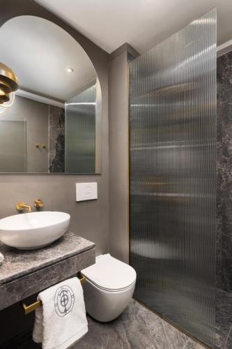a bathroom with a sink and a toilet and a shower at IL CONFORMISTA Casa Storica in Thessaloniki