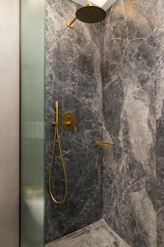 a bathroom with a shower with a glass door at IL CONFORMISTA Casa Storica in Thessaloniki