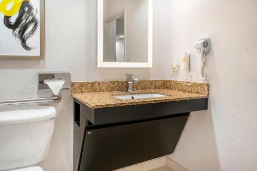 a bathroom with a sink and a toilet at Comfort Inn & Suites in Saint Louis