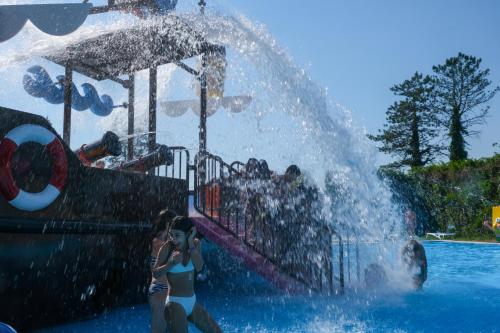 a girl standing in front of a water park at Legends Tskaltubo Spa Resort in Tskaltubo
