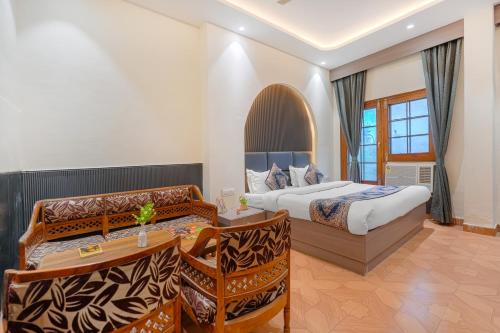 a hotel room with two beds and a desk at Hotel Abhi international in Pathānkot