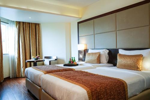 Ramee Guestline Hotel Juhuにあるベッド