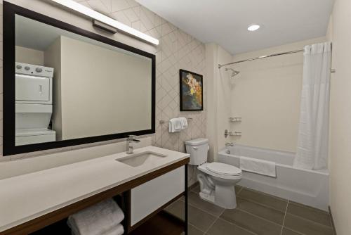 a white bathroom with a sink and a toilet at Everhome Suites Somerset - South Brunswick in Somerset