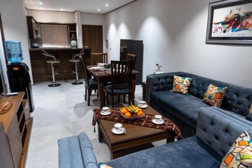 a living room with a couch and a table at Trivelles Executive Suites Islamabad in Islamabad