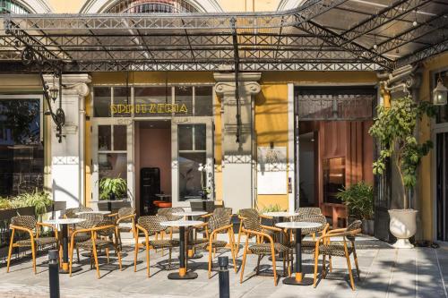 a group of tables and chairs in front of a building at IL CONFORMISTA Casa Storica in Thessaloniki