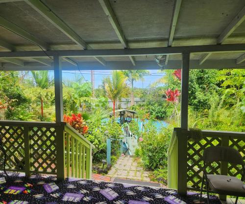 a screened in porch with a view of a garden at Fully renovated 4 bd with 2 master suits, 3 bth home in centralized location in Keaau