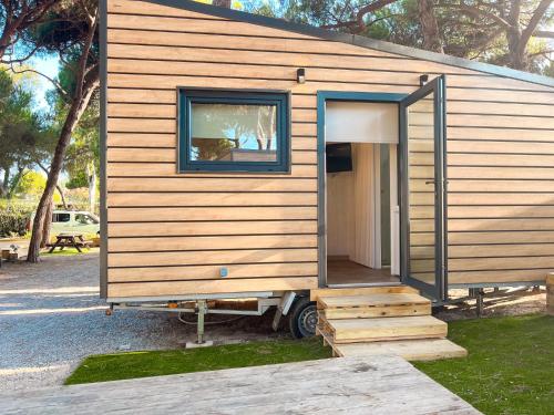 a tiny house on a trailer with a door open at Tres Estrellas in Gavà
