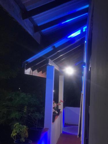 a blue light on a balcony at night at Lakshmi Villa in Aluthgama