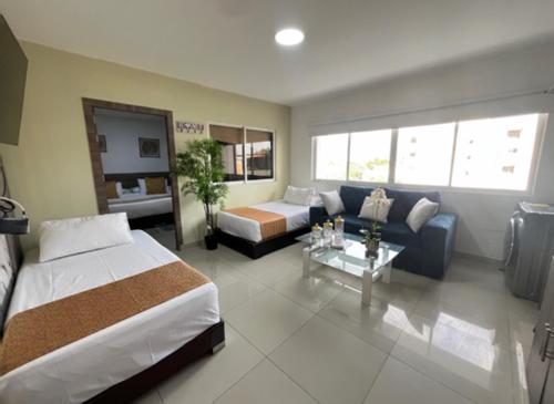 a hotel room with a bed and a couch at Aparta Suites La Flora- Infinity Living in Cali