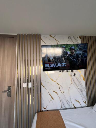 a movie poster on a wall in a hotel room at Aparta Suites La Flora- Infinity Living in Cali
