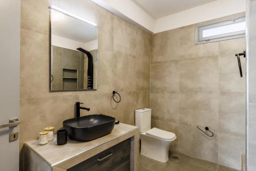 a bathroom with a sink and a toilet at Heaven House in Skopelos Town