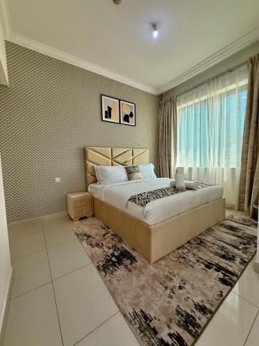 a bedroom with a large bed and a window at Spacious Luxury Lagoon View 2Bhk in Dubai
