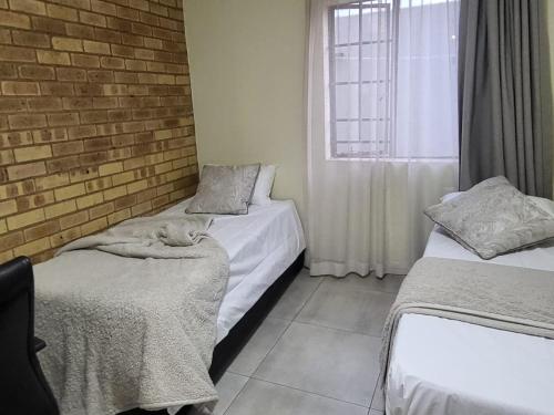 Ένα ή περισσότερα κρεβάτια σε δωμάτιο στο Mhlahlo Guests