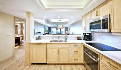 a kitchen with wooden cabinets and a sink at Sanibel Inn in Sanibel