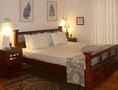 Ένα ή περισσότερα κρεβάτια σε δωμάτιο στο Fairwinds Coorg - Boutique Homestay at Coffee Farm