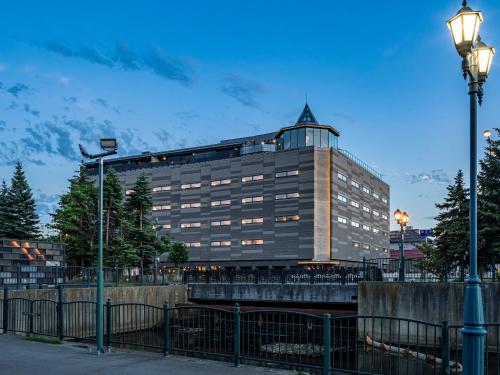 a large building with a tower on top of it at Granbell Hotel Otaru in Otaru