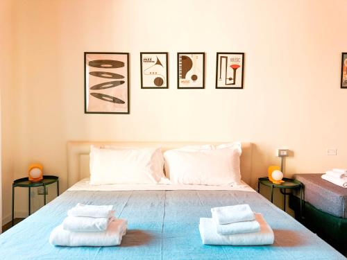 a bedroom with a bed with two towels on it at Ostello Bello Bologna in Bologna