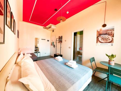 a living room with a couch and red ceilings at Ostello Bello Bologna in Bologna