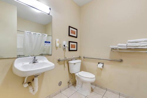 a bathroom with a white toilet and a sink at Comfort Inn & Suites East Moline near I-80 in East Moline