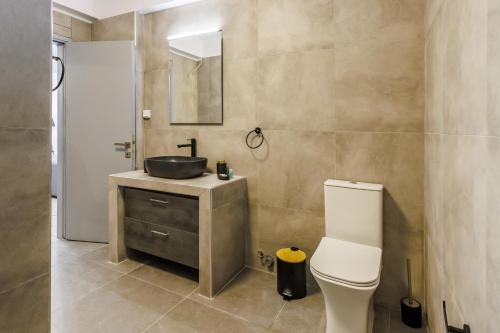 a bathroom with a sink and a toilet at Heaven House in Skopelos Town