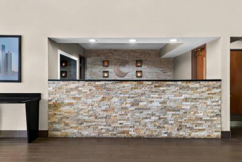 a brick wall in a lobby with a bar at Comfort Inn & Suites in Taylor