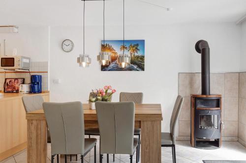 a dining room with a table and a wood stove at Ferienwohnung Zeller in Gaienhofen