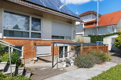 a house with solar panels on the side of it at Ferienwohnung Zeller in Gaienhofen