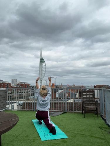 a person holding a tennis racket on a roof at Heart of Old Portsmouth in Portsmouth