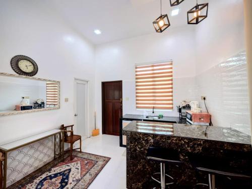 a kitchen with a counter and a sink and a mirror at Mimpi Hillview Homestay in Kuala Terengganu