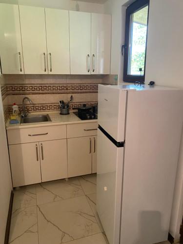 a kitchen with a white refrigerator and a sink at BEATRIS in Ureki