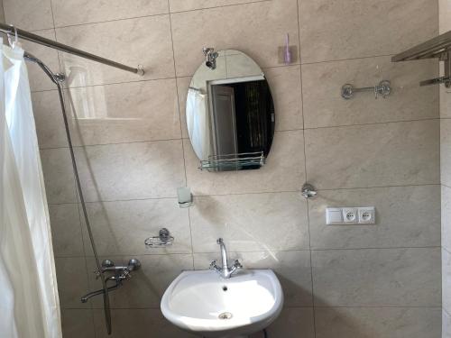a bathroom with a sink and a mirror on the wall at BEATRIS in Ureki