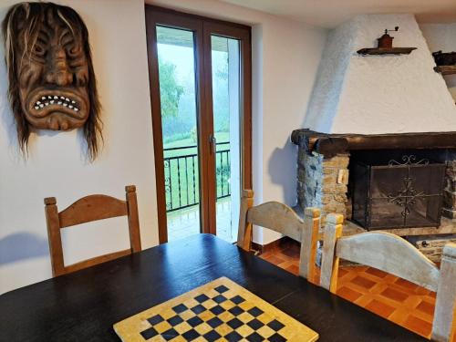 a room with a table and a mask on the wall at Eco della Valle Apartments by Quokka 360 - with views of the surrounding mountains in Faido