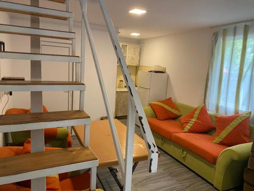 a living room with a ladder and a couch at BEATRIS in Ureki