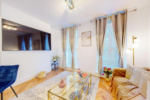 a living room with a couch and a glass table at Stay in Marylebone in London