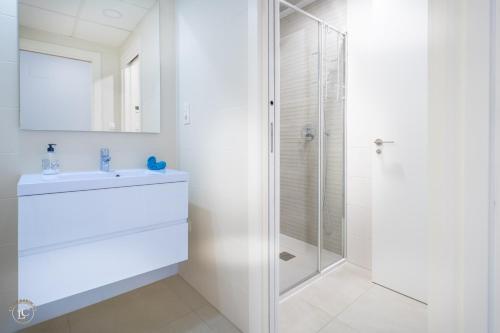 a white bathroom with a shower and a sink at NEW - Flamenca Village - fantastic location! in Orihuela