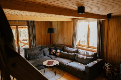 a living room with a leather couch and a table at Dwa Pomosty in Augustów