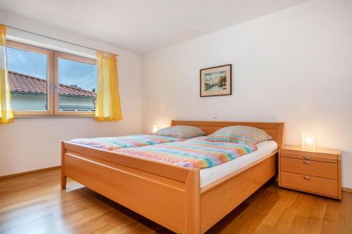 a bedroom with a bed and a window at Ferienhaus Am Kurpark in Bad Waldsee