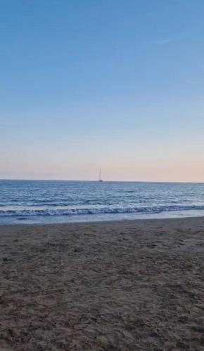a beach with a sail boat in the ocean at Aloha Sicily in Granelli