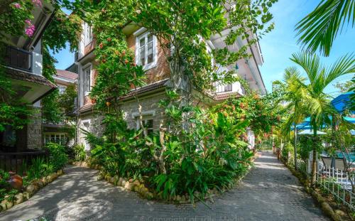 a building with plants on the side of it at Ancient Garden Boutique Hoi An in Hoi An