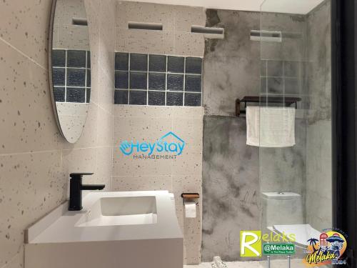 a bathroom with a sink and a mirror at MalayaVilla 5R3B16Pax PrivatePool Karaok PlayGround in Gua Sai