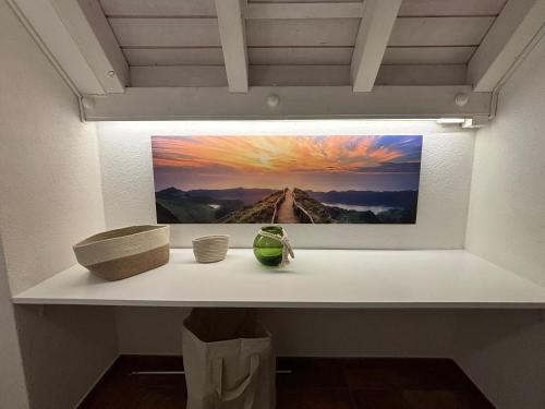 a painting of a mountain on a shelf in a room at Entspannen, private Maisonette Dachwohnung in Dielsdorf