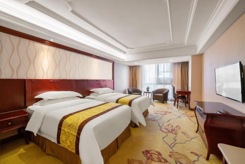 Ένα ή περισσότερα κρεβάτια σε δωμάτιο στο 瑞轩国际酒店