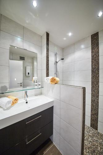 a bathroom with a sink and a mirror at Appartements Der Fuchsbau in Saalbach Hinterglemm