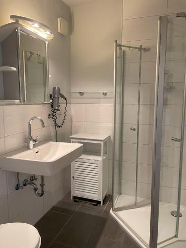 a bathroom with a sink and a shower at Wohnung Südstrand Glück in Fehmarn